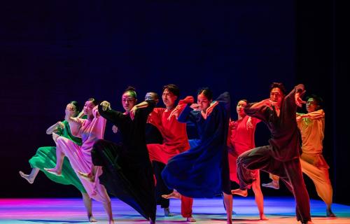 Group of dancers in colorful outfits on stage