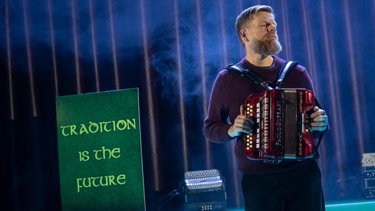 Danny O’Mahony on stage playing an accordion