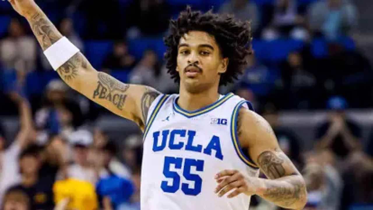 UCLA Men's Basketball player Skyy Clark with his hand in the air