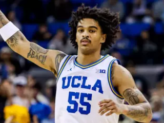 UCLA Men's Basketball player Skyy Clark with his hand in the air
